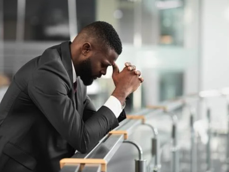 High achieving business man feeling stressed and overwhelmed and burnt out | Primal Reset